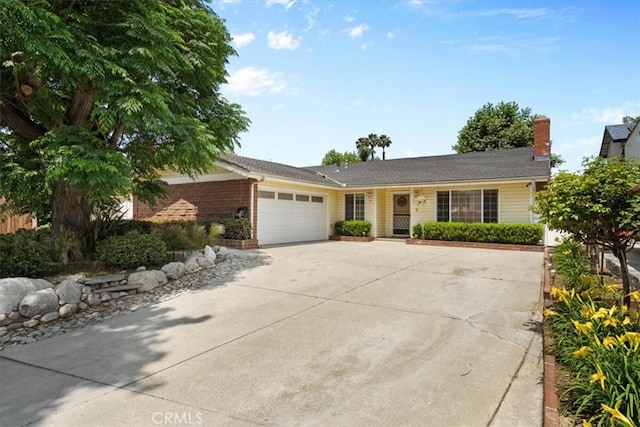 1626 S Boulder Ave, Ontario, CA 91762 - ranch-style home featuring concrete driveway, a garage, and a chimney