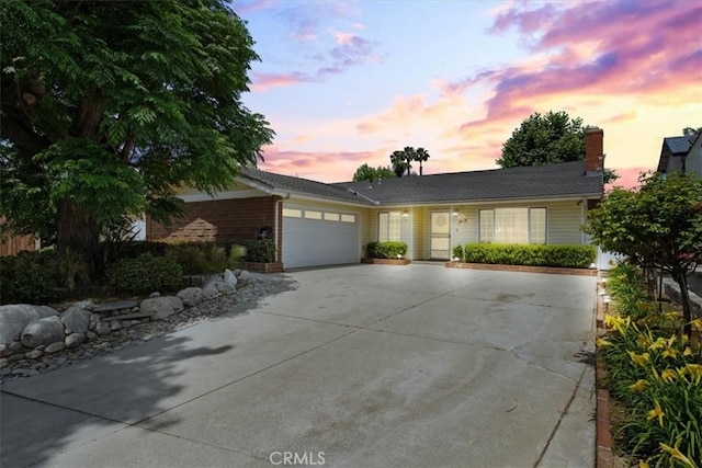 1626 S Boulder Ave, Ontario, CA 91762 - single story home with concrete driveway, an attached garage, and brick siding