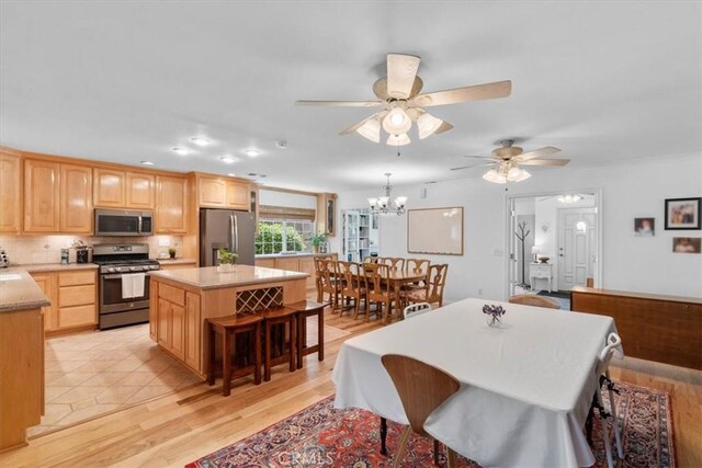 1626 S Boulder Ave, Ontario, CA 91762 - dining area featuring ceiling fan, a chandelier, and light wood-type flooring