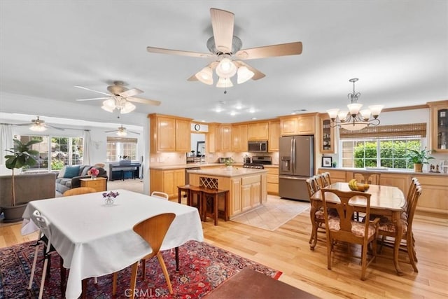 1626 S Boulder Ave, Ontario, CA 91762 - dining space with light wood finished floors, a chandelier, ornamental molding, and ceiling fan