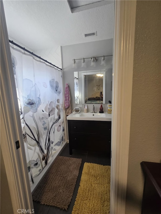 1212 Gen Ct, Barstow, CA 92311 - full bath with vanity, a textured ceiling, and curtained shower