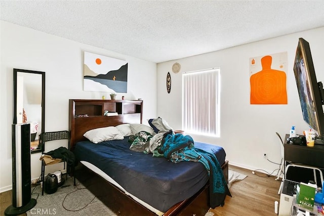 121 E Live Oak St, San Gabriel, CA 91776 - bedroom featuring wood finished floors and a textured ceiling
