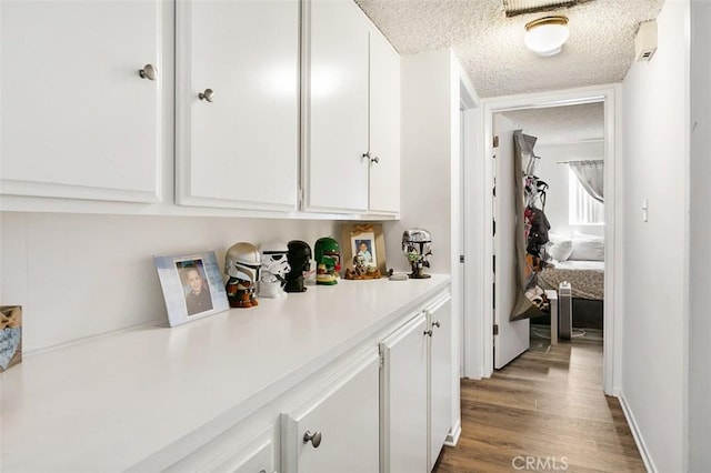 121 E Live Oak St, San Gabriel, CA 91776 - hallway featuring a textured ceiling and wood finished floors