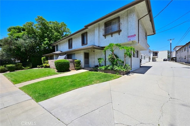 121 E Live Oak St, San Gabriel, CA 91776 - view of front facade with a front lawn, stucco siding, and concrete driveway