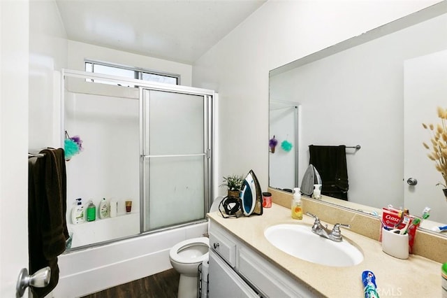 121 E Live Oak St, San Gabriel, CA 91776 - full bathroom featuring toilet, vanity, enclosed tub / shower combo, and wood finished floors