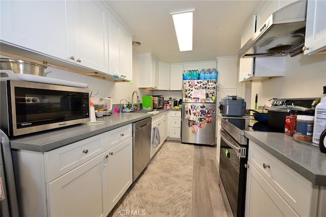 121 E Live Oak St, San Gabriel, CA 91776 - kitchen featuring stainless steel appliances, under cabinet range hood, a sink, white cabinets, and light wood-style floors