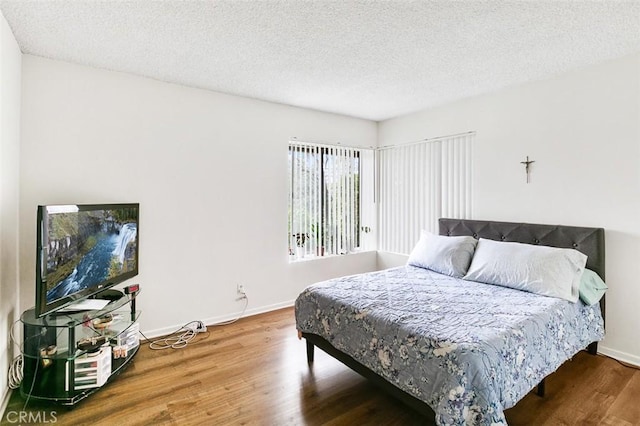 121 E Live Oak St, San Gabriel, CA 91776 - bedroom featuring wood finished floors, baseboards, and a textured ceiling
