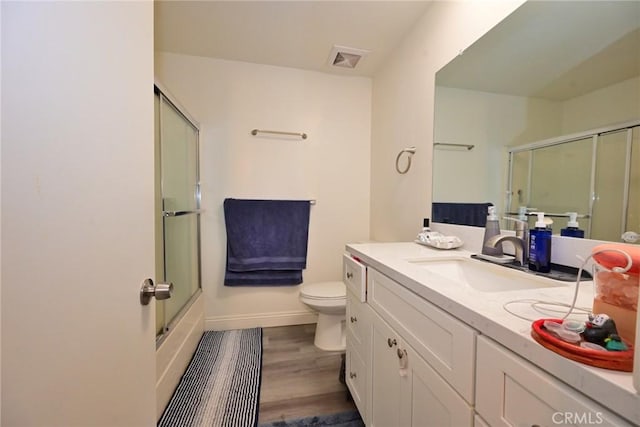 121 E Live Oak St, San Gabriel, CA 91776 - full bath with vanity, toilet, baseboards, wood finished floors, and bath / shower combo with glass door