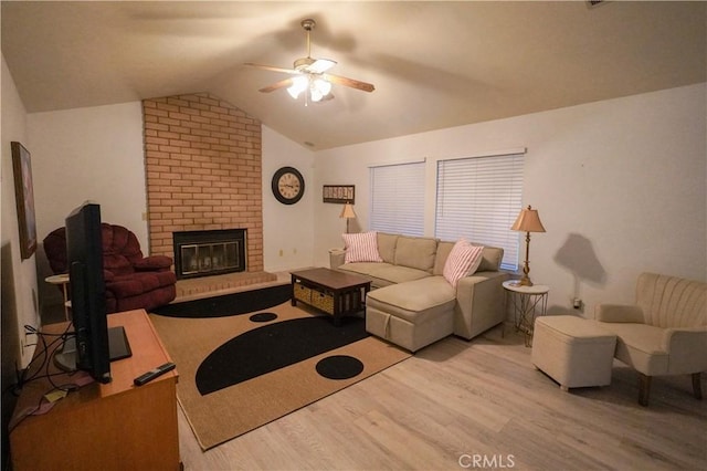 5030 Cardiff Ln, Atwater, CA 95301 - living room featuring a ceiling fan, wood finished floors, vaulted ceiling, and a brick fireplace