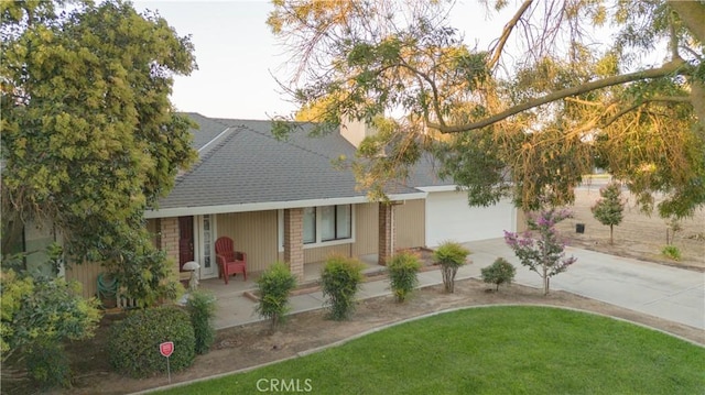 5030 Cardiff Ln, Atwater, CA 95301 - view of front of home featuring concrete driveway, a shingled roof, covered porch, and a front yard