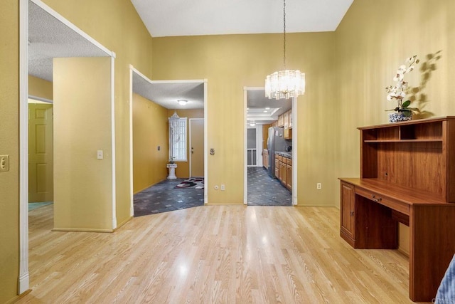 1518 Goldrush Way, Oceanside, CA 92057 - unfurnished dining area with light wood finished floors and a chandelier