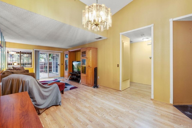 1518 Goldrush Way, Oceanside, CA 92057 - living room with wood finished floors, a chandelier, and high vaulted ceiling