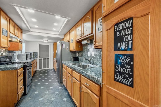 1518 Goldrush Way, Oceanside, CA 92057 - kitchen with appliances with stainless steel finishes, a tray ceiling, backsplash, brown cabinets, and recessed lighting