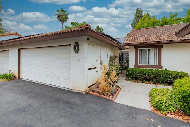1518 Goldrush Way, Oceanside, CA 92057 - view of front of home featuring stucco siding, a tile roof, a garage, and an outdoor structure
