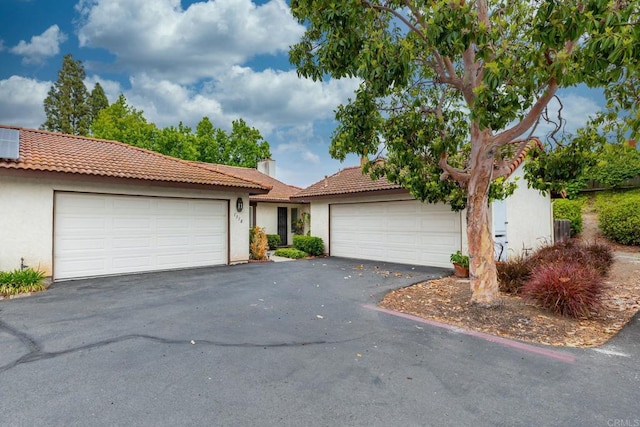 1518 Goldrush Way, Oceanside, CA 92057 - view of front of house featuring a garage, stucco siding, driveway, and a tile roof