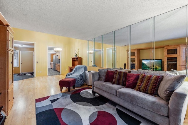 1518 Goldrush Way, Oceanside, CA 92057 - living room with wood finished floors, a chandelier, and a textured ceiling