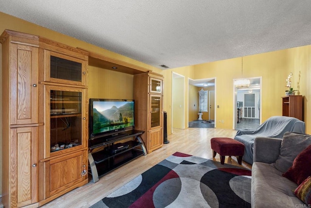 1518 Goldrush Way, Oceanside, CA 92057 - living area with light wood-style flooring and a textured ceiling