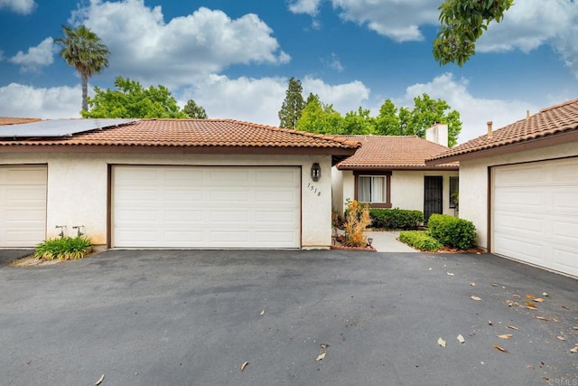 1518 Goldrush Way, Oceanside, CA 92057 - view of front of home with stucco siding, solar panels, a tile roof, and driveway