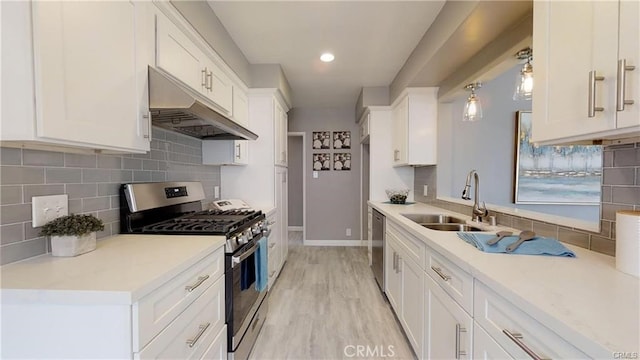 6008 Amos Ave, Lakewood, CA 90712 - kitchen with appliances with stainless steel finishes, under cabinet range hood, tasteful backsplash, white cabinets, and recessed lighting