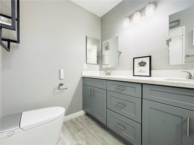 6008 Amos Ave, Lakewood, CA 90712 - bathroom featuring double vanity and toilet