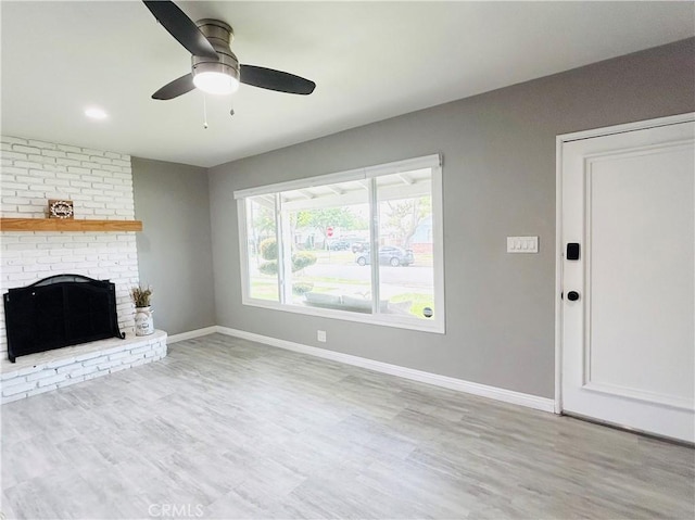 6008 Amos Ave, Lakewood, CA 90712 - unfurnished living room with ceiling fan, wood finished floors, and a brick fireplace