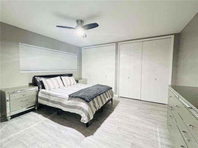 6008 Amos Ave, Lakewood, CA 90712 - bedroom featuring multiple closets, light wood-style flooring, and a ceiling fan