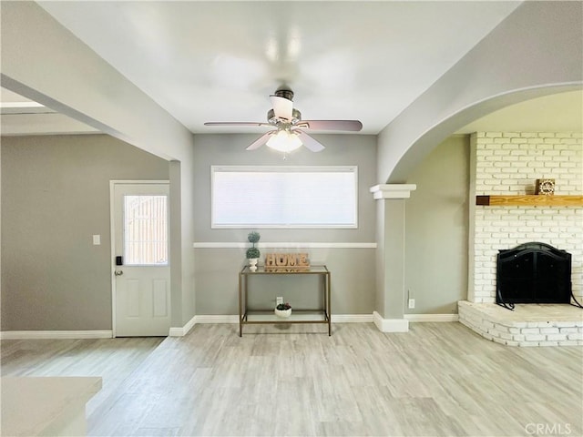 6008 Amos Ave, Lakewood, CA 90712 - entryway featuring a ceiling fan, wood finished floors, a fireplace, and arched walkways