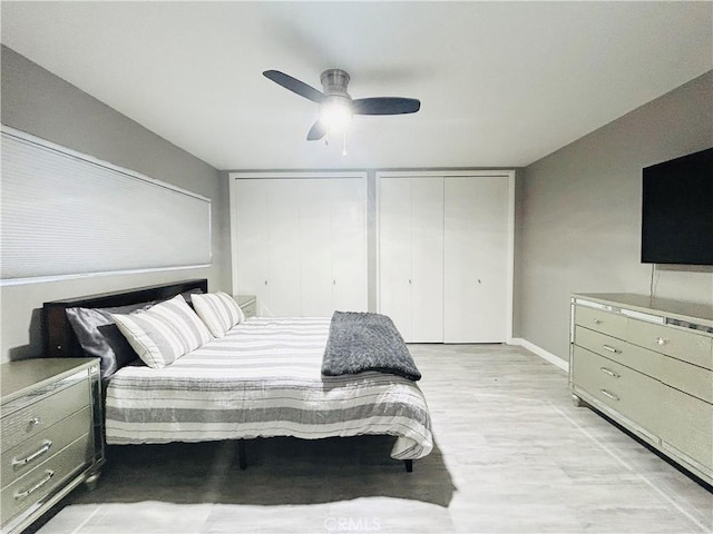 6008 Amos Ave, Lakewood, CA 90712 - bedroom featuring two closets, light wood finished floors, and a ceiling fan