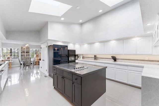19 Gateview Dr, Fallbrook, CA 92028 - kitchen featuring a skylight, white cabinetry, recessed lighting, light tile patterned floors, and electric cooktop