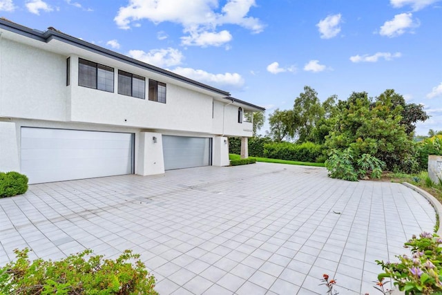 19 Gateview Dr, Fallbrook, CA 92028 - view of home's exterior with an attached garage, stucco siding, and driveway