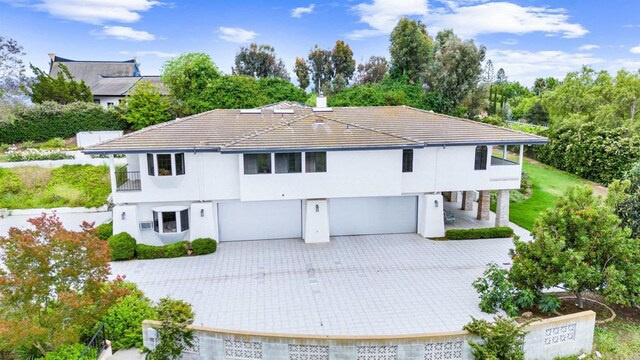 19 Gateview Dr, Fallbrook, CA 92028 - view of front of home with a garage, driveway, a chimney, and a balcony