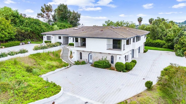 19 Gateview Dr, Fallbrook, CA 92028 - view of front of home featuring stairway, stone siding, decorative driveway, a balcony, and a garage