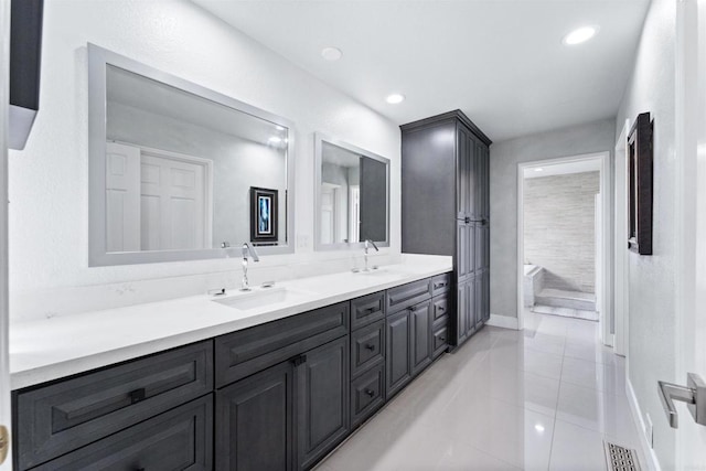 19 Gateview Dr, Fallbrook, CA 92028 - bathroom featuring double vanity, tile patterned floors, recessed lighting, a tub, and baseboards