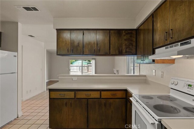 1018 Greenwich Dr, Chico, CA 95926 - kitchen with white appliances, under cabinet range hood, light countertops, a peninsula, and dark brown cabinetry
