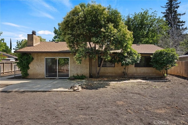 1018 Greenwich Dr, Chico, CA 95926 - back of house with a patio area, a chimney, and stucco siding