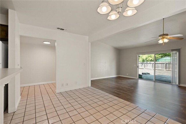 1018 Greenwich Dr, Chico, CA 95926 - spare room with ceiling fan, baseboards, light tile patterned floors, and a chandelier