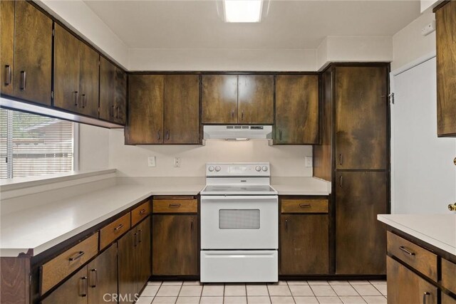 1018 Greenwich Dr, Chico, CA 95926 - kitchen with electric range, under cabinet range hood, light countertops, and light tile patterned flooring