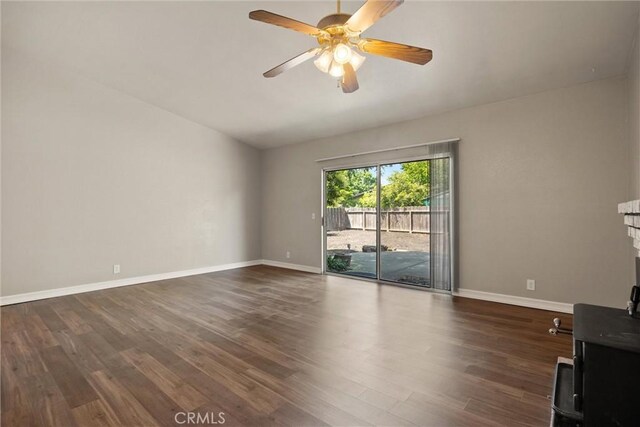 1018 Greenwich Dr, Chico, CA 95926 - unfurnished living room featuring baseboards, dark wood-type flooring, a ceiling fan, and vaulted ceiling