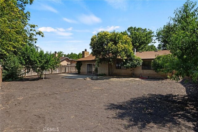 1018 Greenwich Dr, Chico, CA 95926 - back of property with stucco siding and a patio