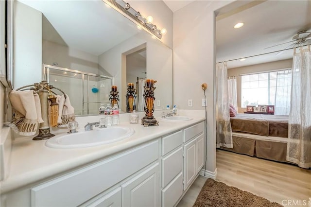 1251 Pepperwood Ct, Carson, CA 90746 - bathroom featuring double vanity, a stall shower, wood finished floors, ensuite bath, and recessed lighting