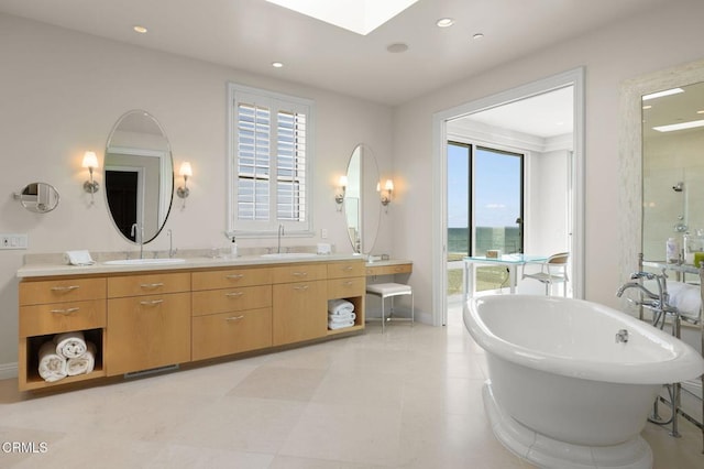 1135 Capri Way, Oxnard, CA 93035 - bathroom featuring double vanity, a soaking tub, recessed lighting, a skylight, and a shower