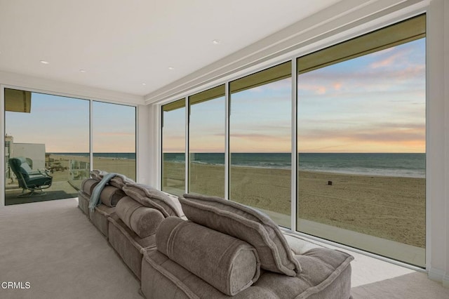 1135 Capri Way, Oxnard, CA 93035 - sunroom with carpet floors, view of water and beach, and floor to ceiling windows