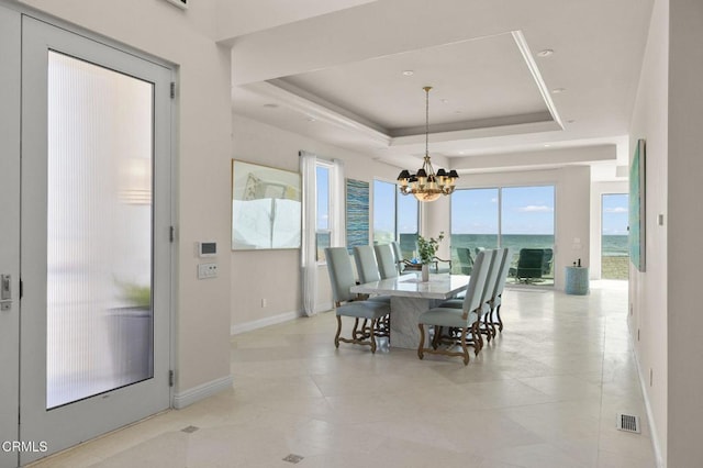 1135 Capri Way, Oxnard, CA 93035 - dining area with a raised ceiling, a chandelier, and a water view