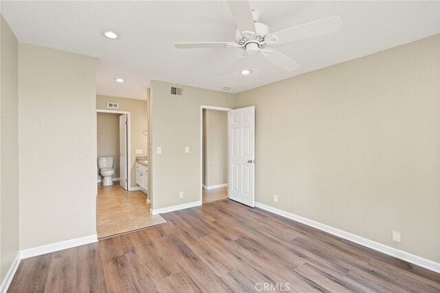 2554 Olive Dr Unit 38, Palmdale, CA 93550 - unfurnished bedroom with wood finished floors, recessed lighting, ensuite bathroom, baseboards, and a ceiling fan