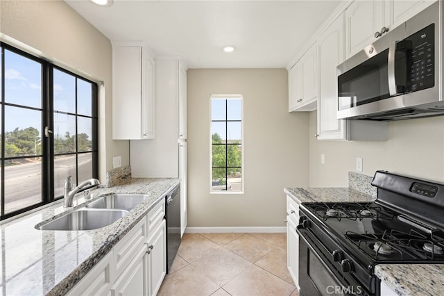 2554 Olive Dr Unit 38, Palmdale, CA 93550 - kitchen with gas range oven, stainless steel microwave, dishwashing machine, a sink, and baseboards