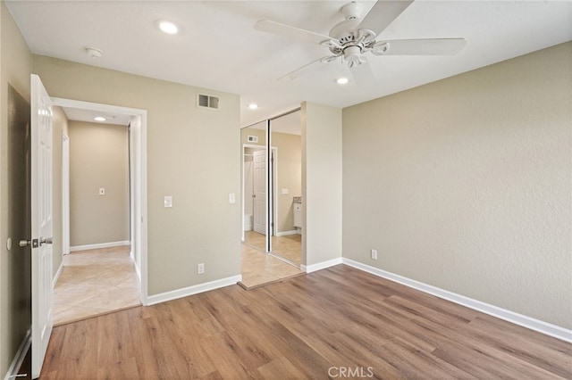 2554 Olive Dr Unit 38, Palmdale, CA 93550 - unfurnished bedroom with wood finished floors, recessed lighting, a closet, baseboards, and ceiling fan