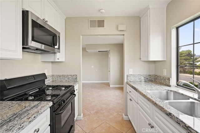 2554 Olive Dr Unit 38, Palmdale, CA 93550 - kitchen featuring black range with gas stovetop, stainless steel microwave, a sink, and white cabinets