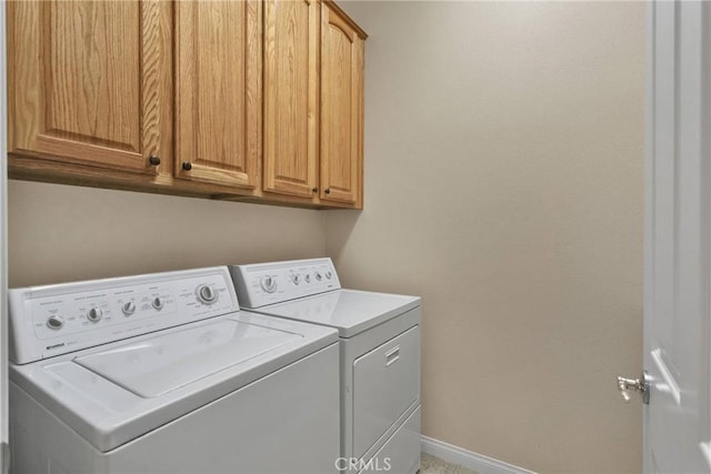 10479 Bridge Haven Rd, Apple Valley, CA 92308 - washroom with separate washer and dryer, cabinet space, and baseboards