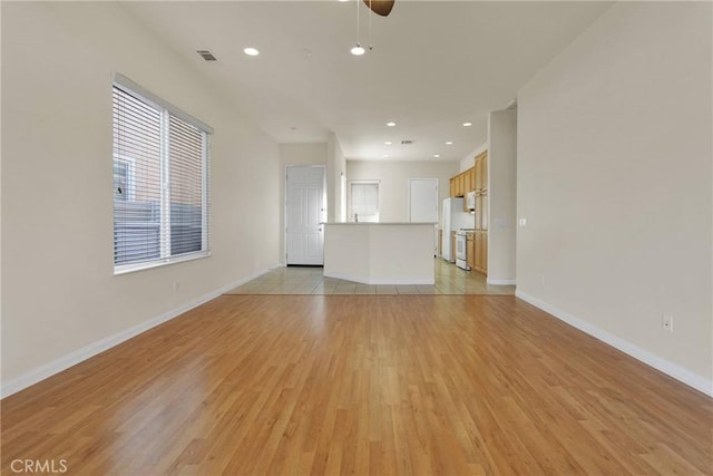 10479 Bridge Haven Rd, Apple Valley, CA 92308 - unfurnished living room featuring light wood-type flooring, plenty of natural light, baseboards, recessed lighting, and ceiling fan