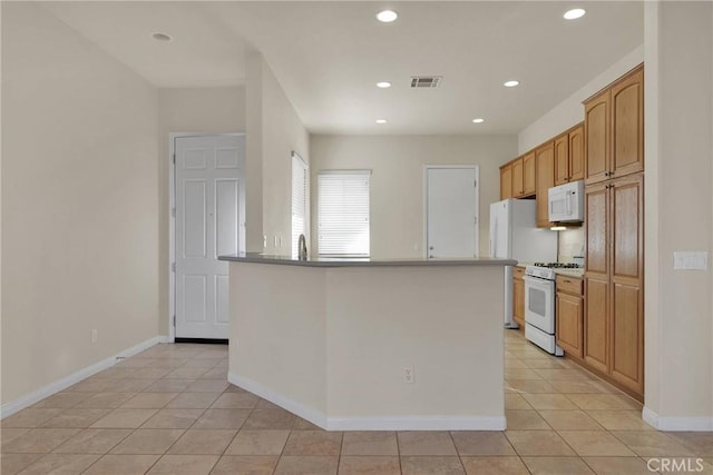 10479 Bridge Haven Rd, Apple Valley, CA 92308 - kitchen featuring white appliances, light tile patterned floors, recessed lighting, baseboards, and a sink